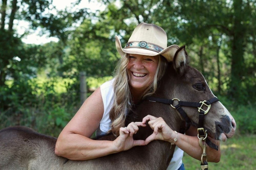Making a heart with a horse at golden hour