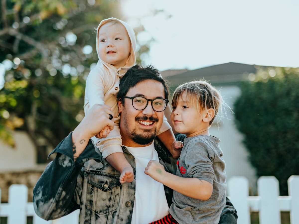 Parents swinging their child between them on a walking path